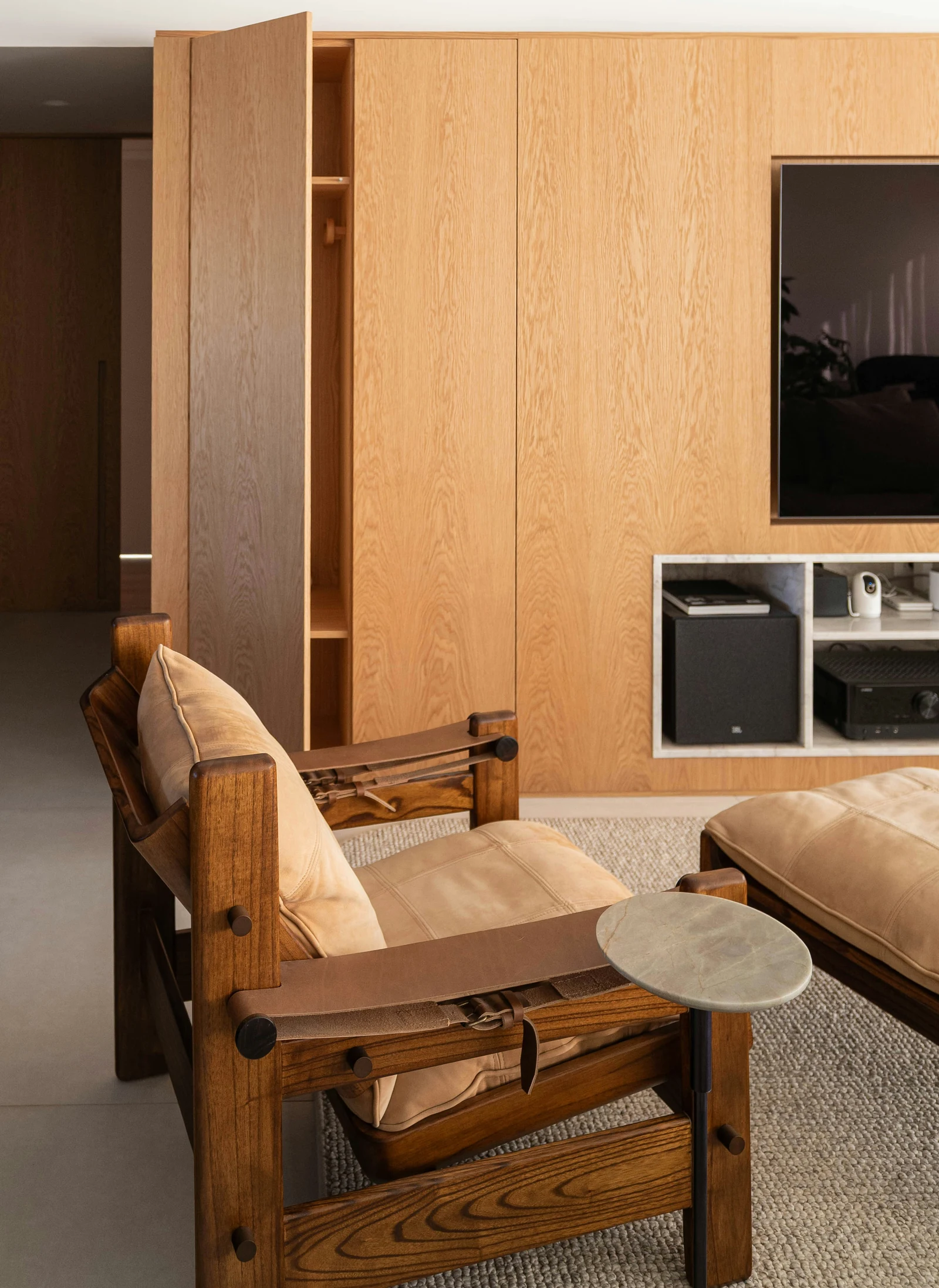 Reference photo of an interior with wooden wall storage and wooden chairs